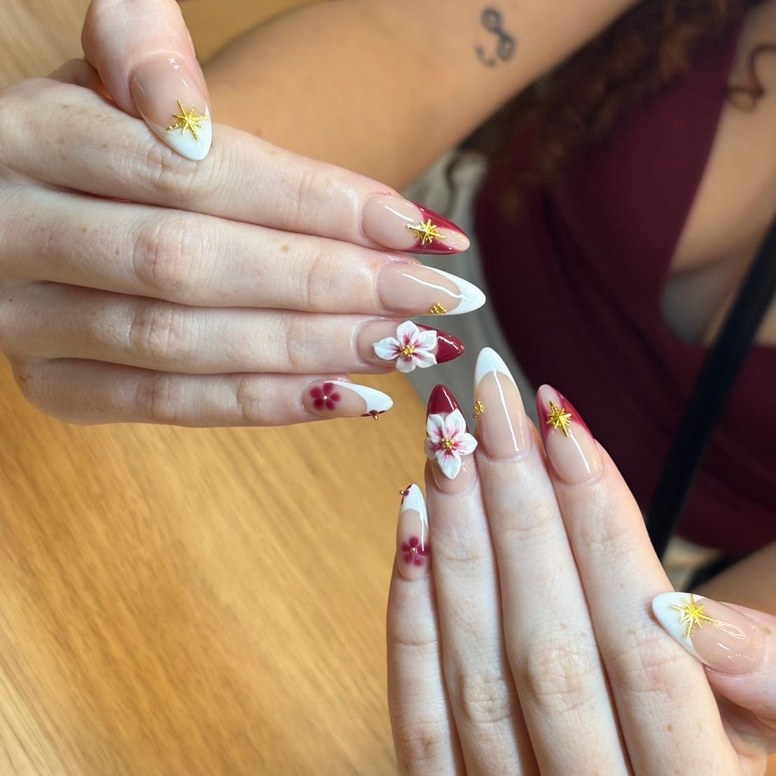 Long white nails with floral and star designs