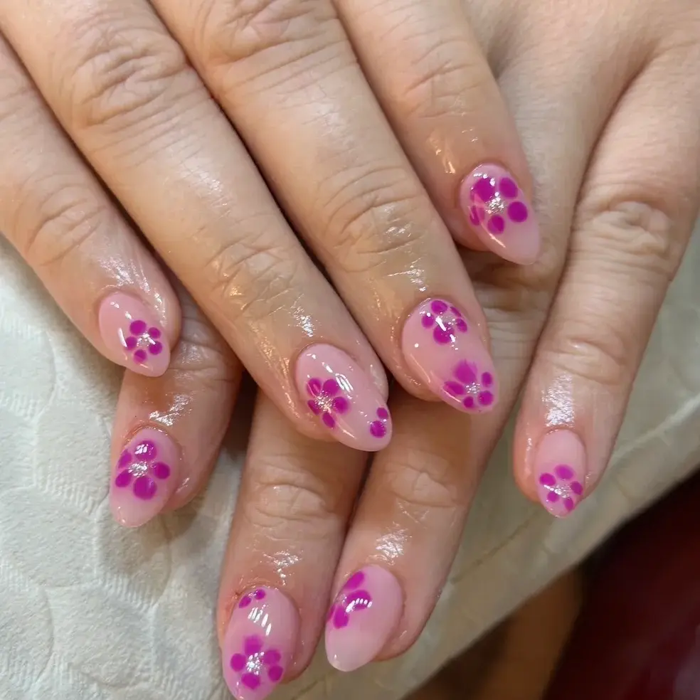 Pink nails with purple floral designs