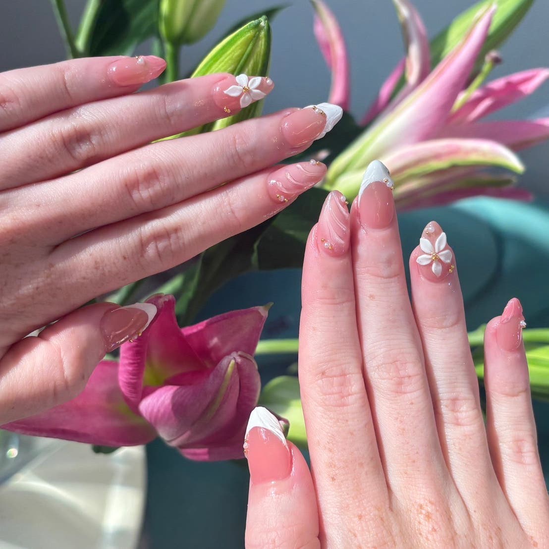 Pink French manicure with sculpted white flowers