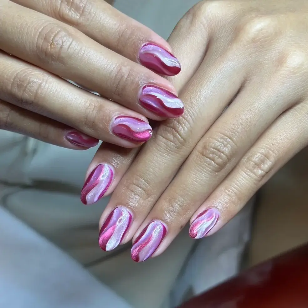 Pink and white swirl gel nails