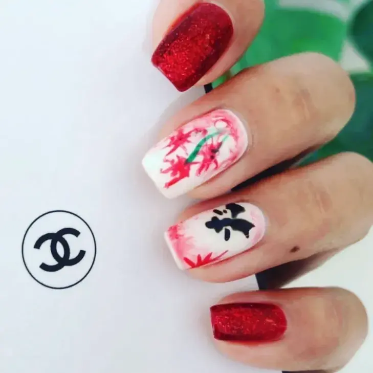 Red glitter and white floral nail art