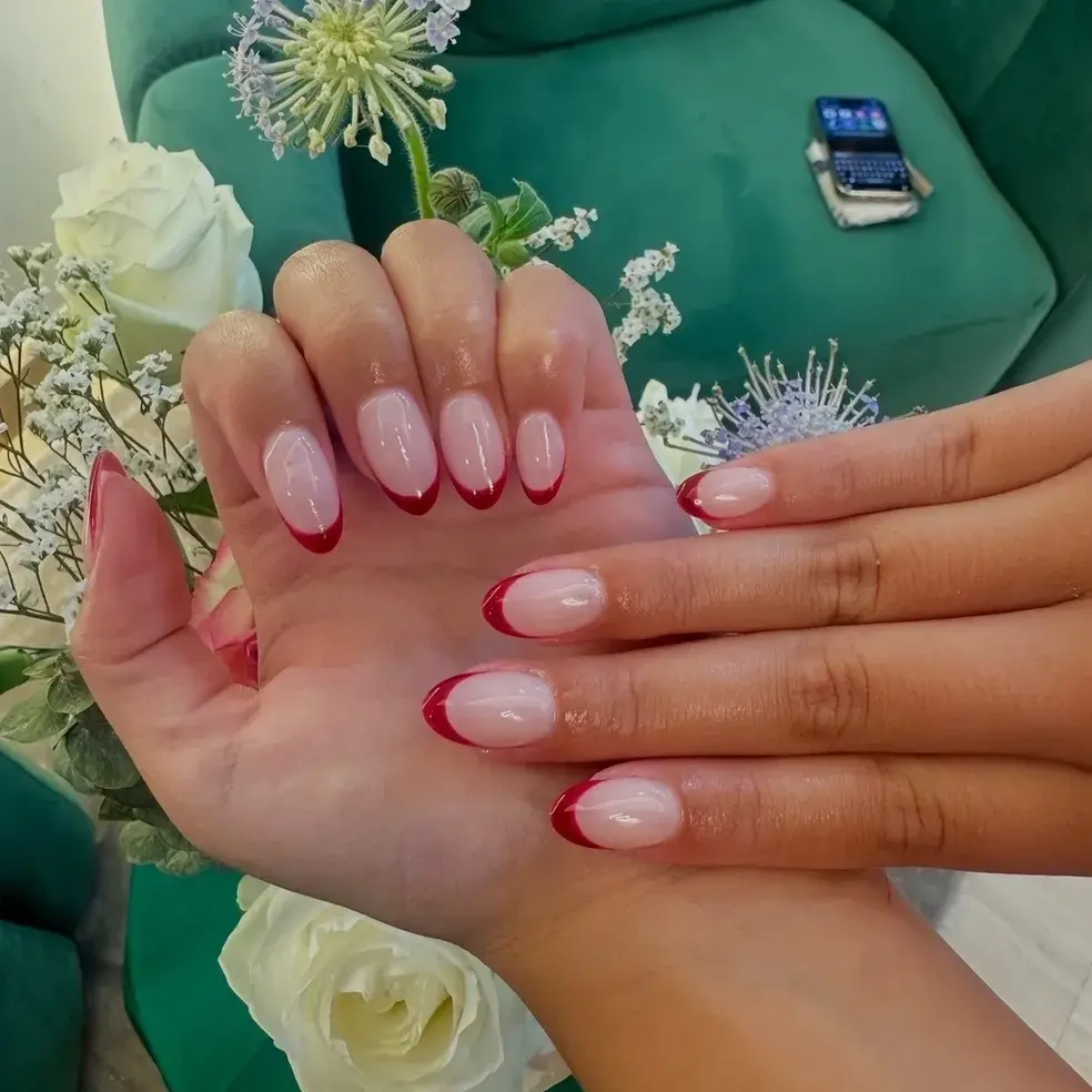 Soft pink French manicure with a red accent