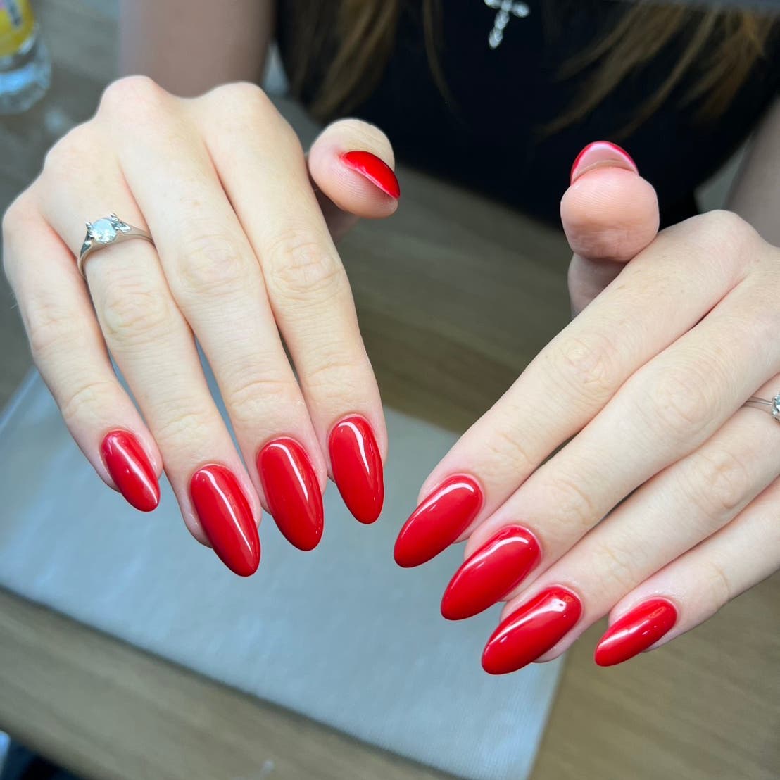 Glossy red almond-shaped nails