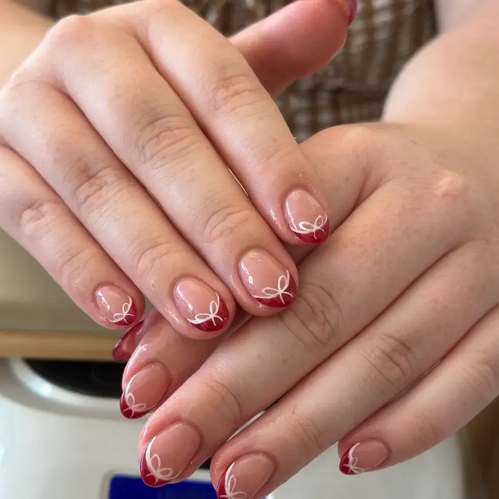 Red and white bow nail art
