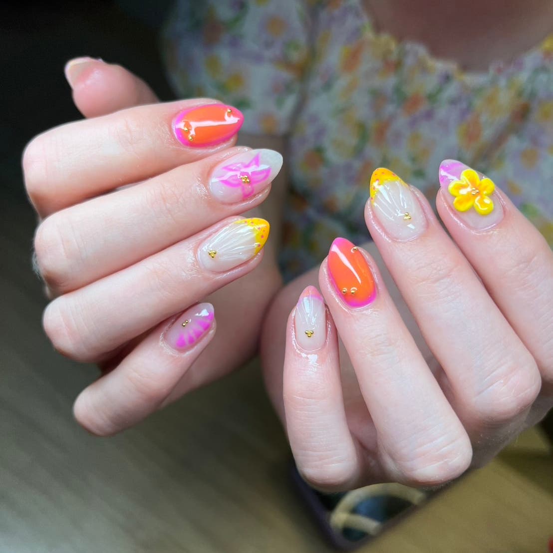 Bright orange and pink floral gel nail art
