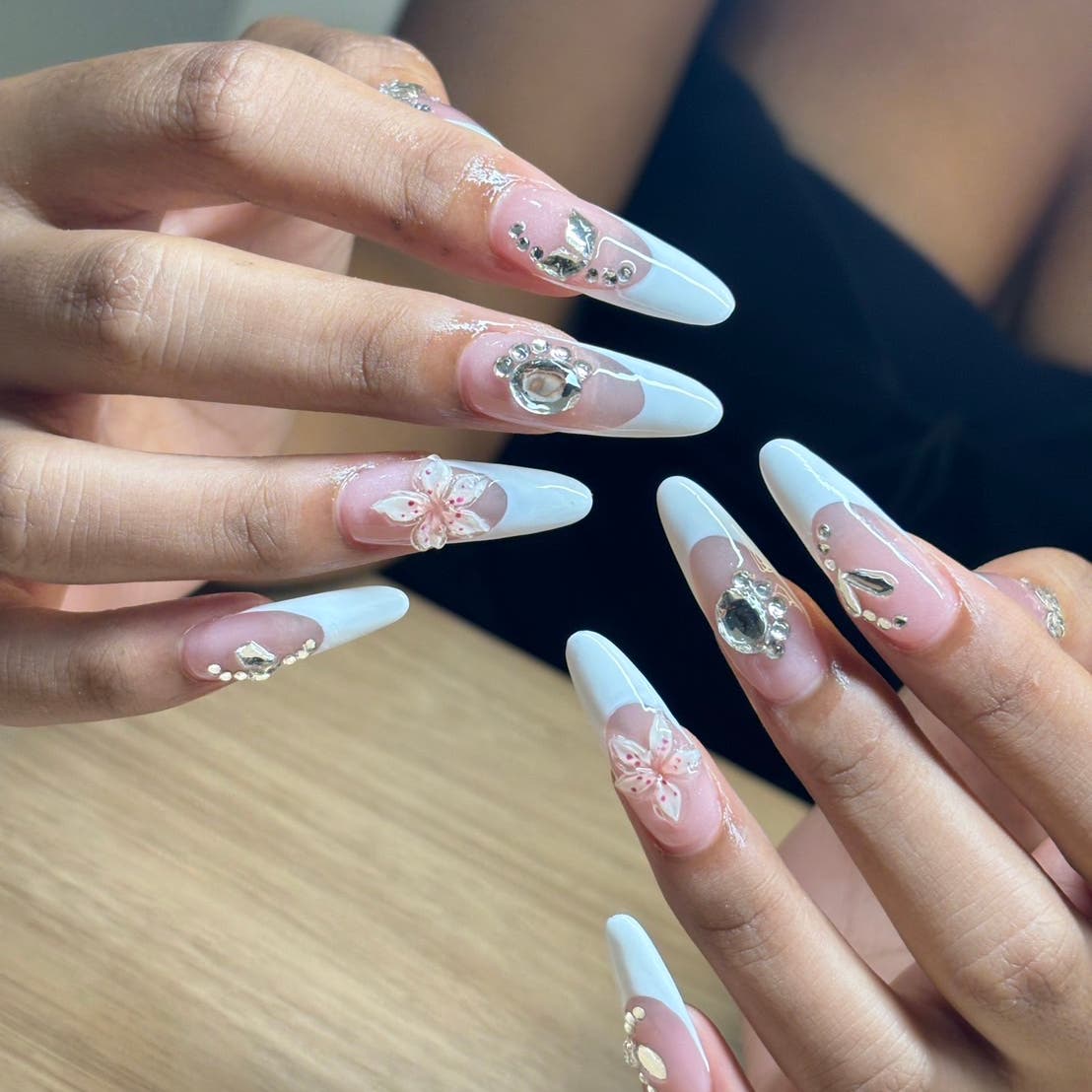White and pink nails with flowers and gemstones
